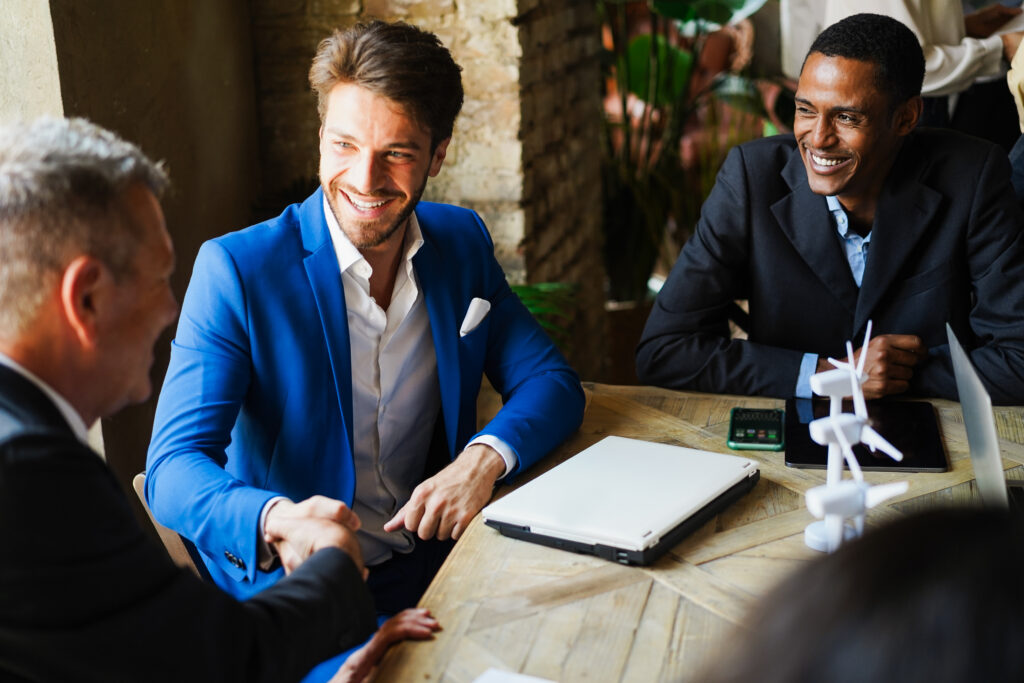 Business professionals shaking hands after a positive meeting and a closed deal.