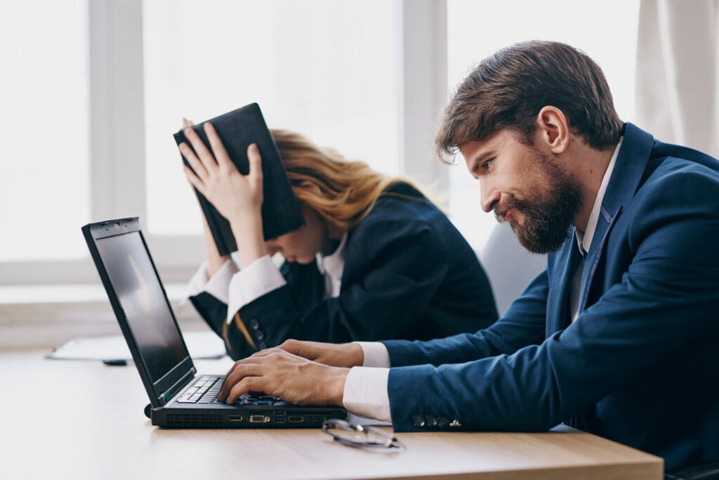 Two business professionals looking stressed at work.